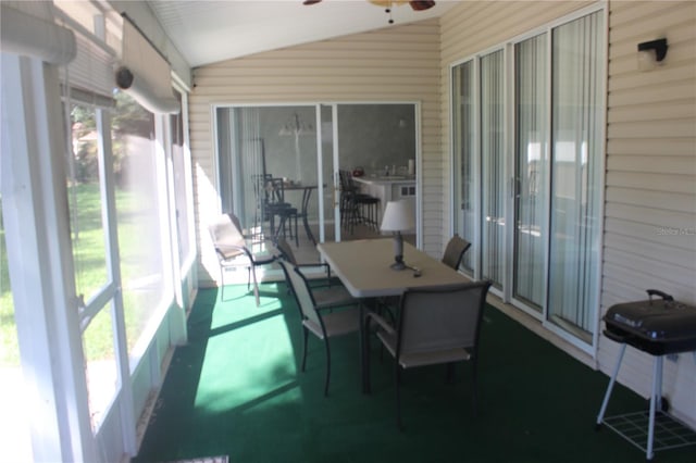 sunroom featuring ceiling fan and vaulted ceiling