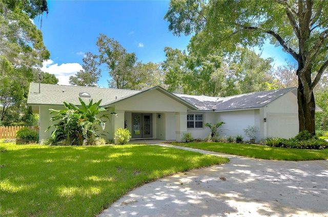 ranch-style house with a garage and a front yard