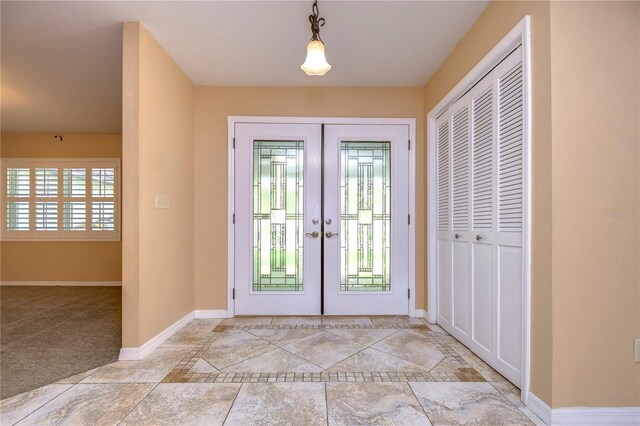 foyer entrance featuring light tile patterned floors and french doors