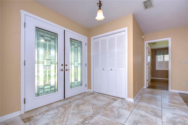 tiled entrance foyer featuring a wealth of natural light