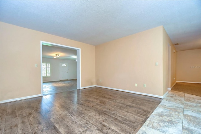 empty room featuring hardwood / wood-style floors and a textured ceiling