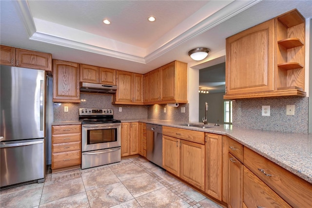 kitchen featuring sink, appliances with stainless steel finishes, backsplash, and a raised ceiling