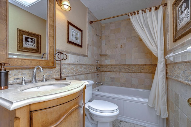 full bathroom featuring tasteful backsplash, shower / bathtub combination with curtain, a textured ceiling, toilet, and vanity