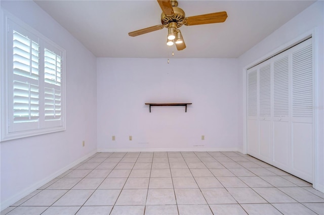 unfurnished bedroom featuring a closet, light tile patterned floors, and ceiling fan