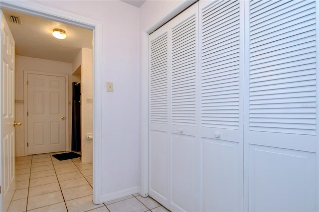 hallway with light tile patterned floors