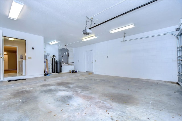 garage with a garage door opener and heating unit