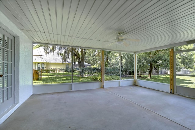 unfurnished sunroom with ceiling fan