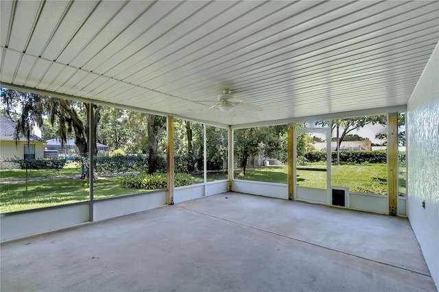 unfurnished sunroom with ceiling fan