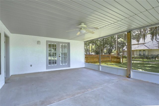 unfurnished sunroom featuring french doors and ceiling fan