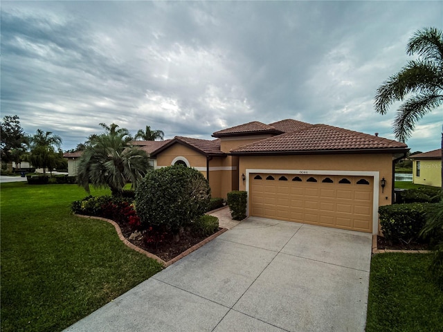 mediterranean / spanish-style home with a front lawn and a garage