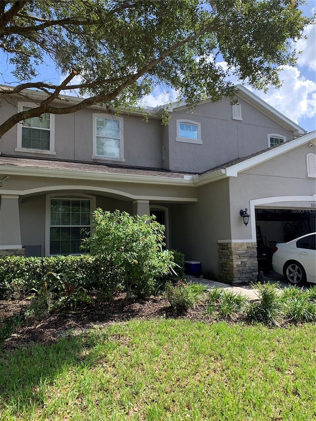 32502 Summerglade Dr, Wesley Chapel, FL 33545 - traditional-style house with stucco siding, a garage, and stone siding