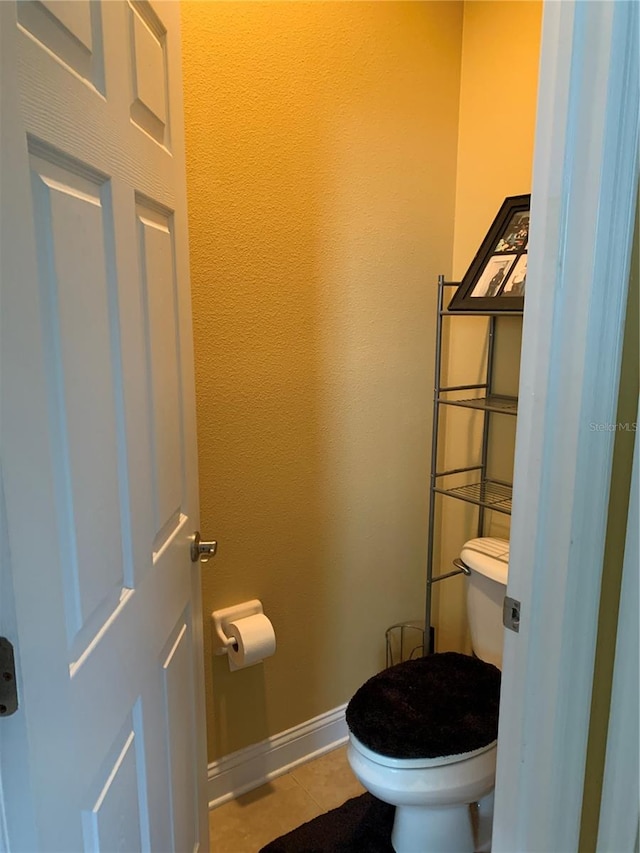 bathroom with tile patterned floors and toilet