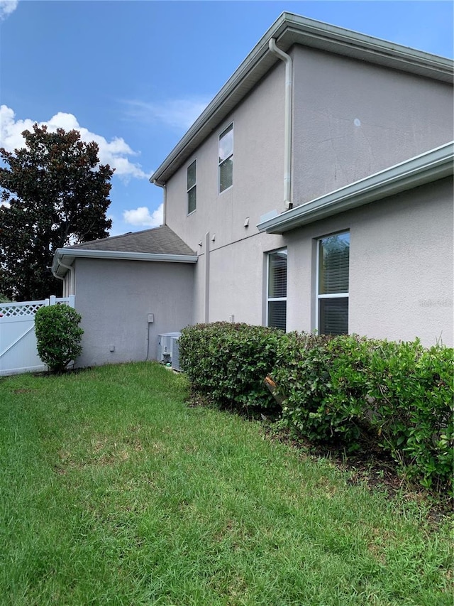 32502 Summerglade Dr, Wesley Chapel, FL 33545 - view of property exterior featuring stucco siding and central AC