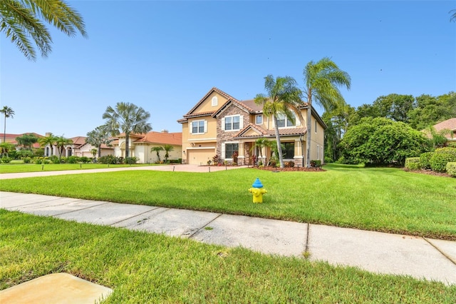 view of front of house featuring a garage and a front lawn