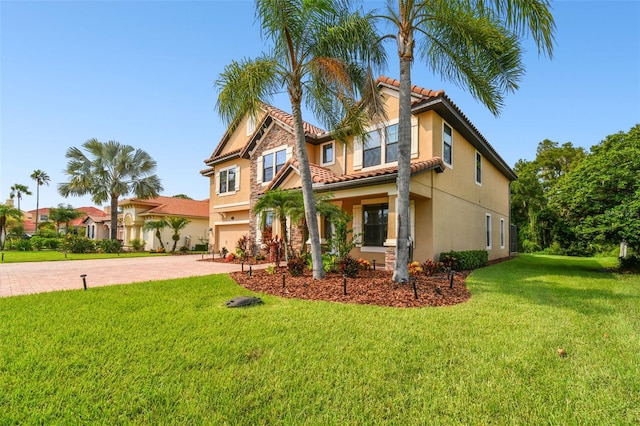 view of front of property with a front yard and a garage