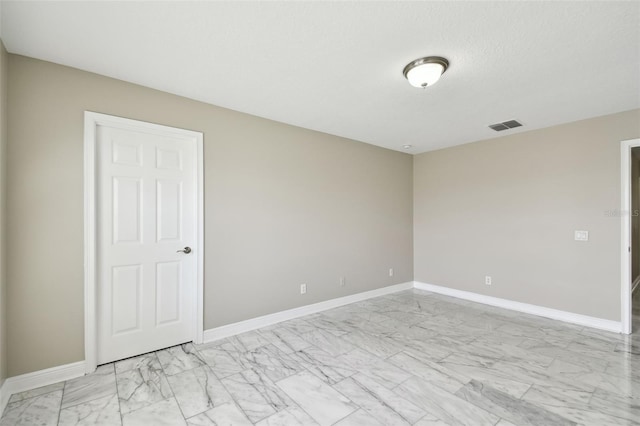 unfurnished room with a textured ceiling