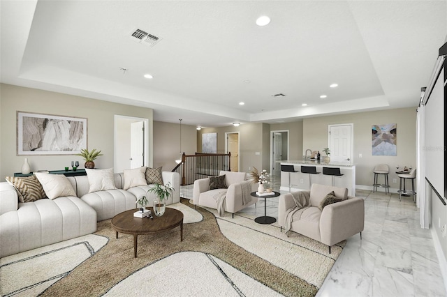 living room with a raised ceiling