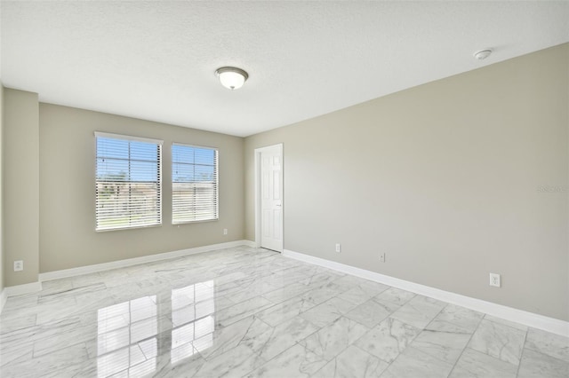 spare room featuring a textured ceiling