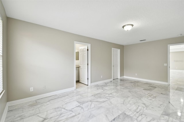 spare room with a textured ceiling