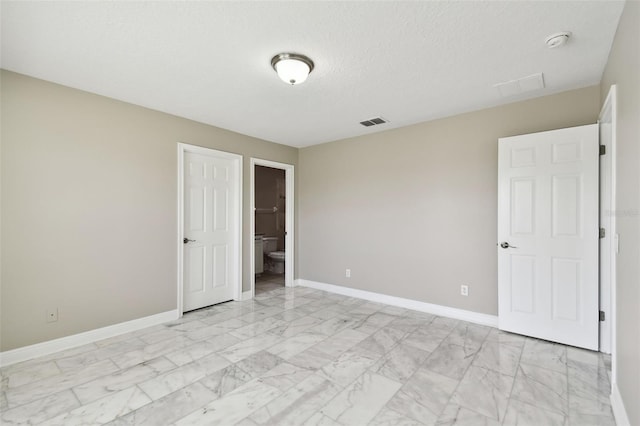 unfurnished room with a textured ceiling