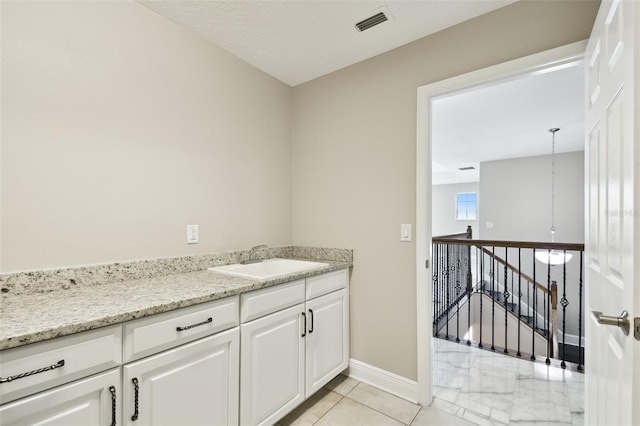 bathroom featuring tile patterned flooring and vanity