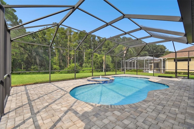 view of swimming pool with an in ground hot tub, a patio area, and a lanai