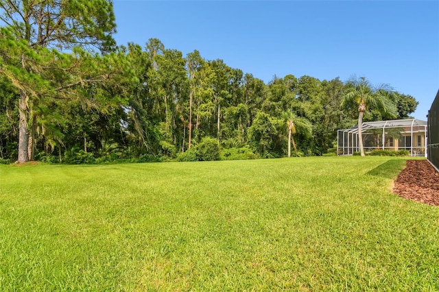 view of yard with glass enclosure