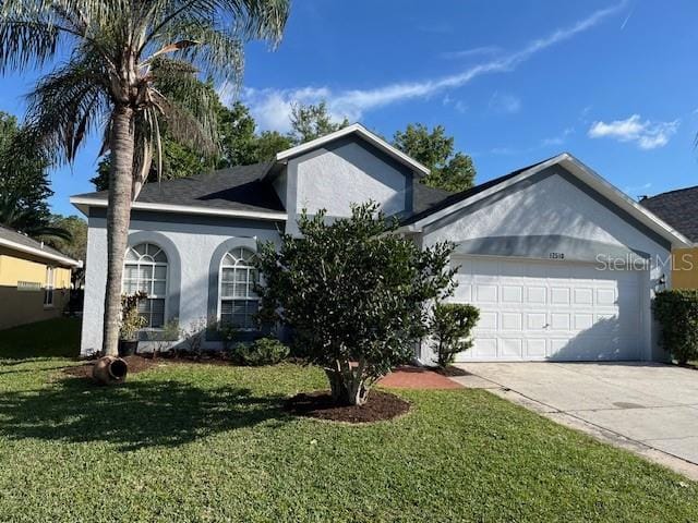 ranch-style house with an attached garage, stucco siding, concrete driveway, and a front yard