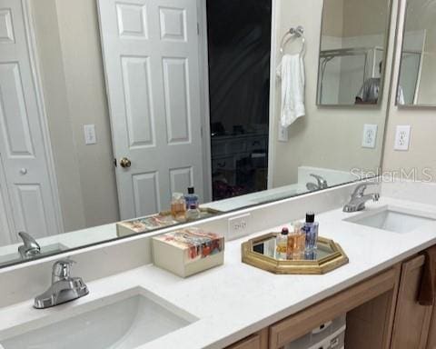 full bath featuring double vanity and a sink