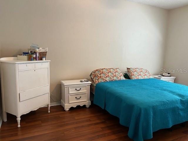 bedroom featuring dark wood-type flooring