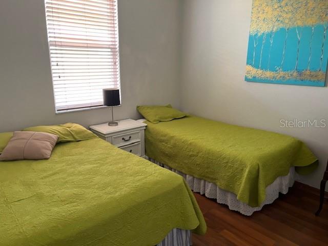 bedroom with dark hardwood / wood-style flooring