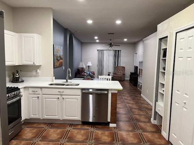 kitchen featuring kitchen peninsula, ceiling fan, white cabinetry, sink, and stainless steel appliances