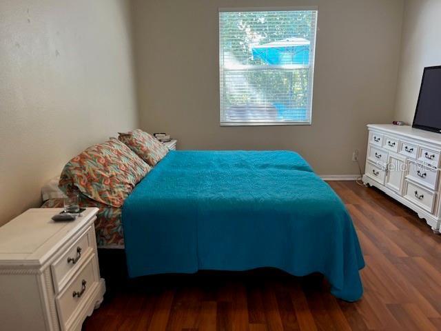 bedroom featuring dark hardwood / wood-style flooring