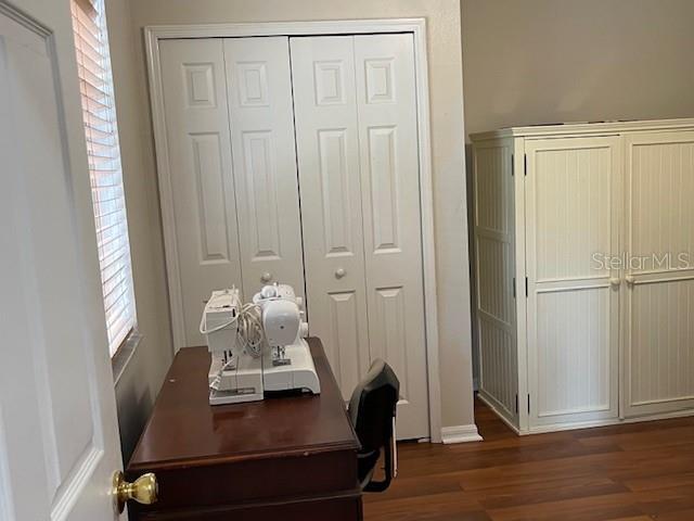 home office with dark hardwood / wood-style floors