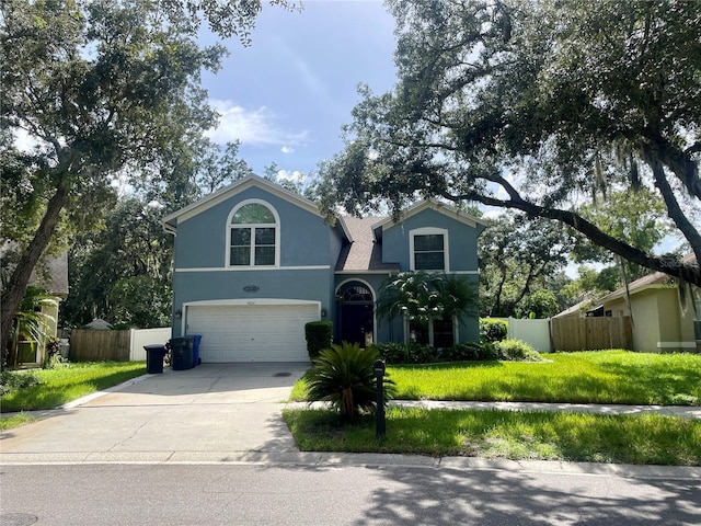 view of property with a front yard and a garage