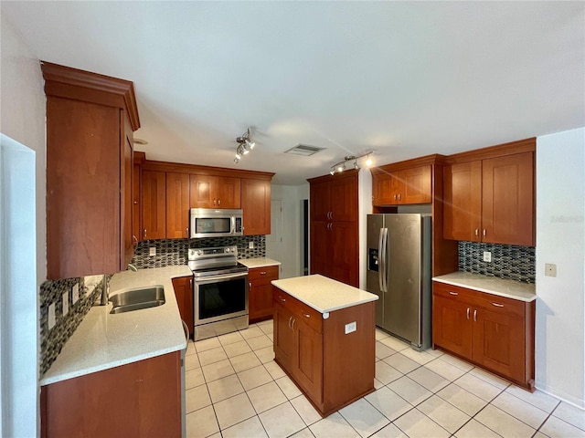 kitchen featuring tasteful backsplash, a center island, sink, stainless steel appliances, and light stone counters