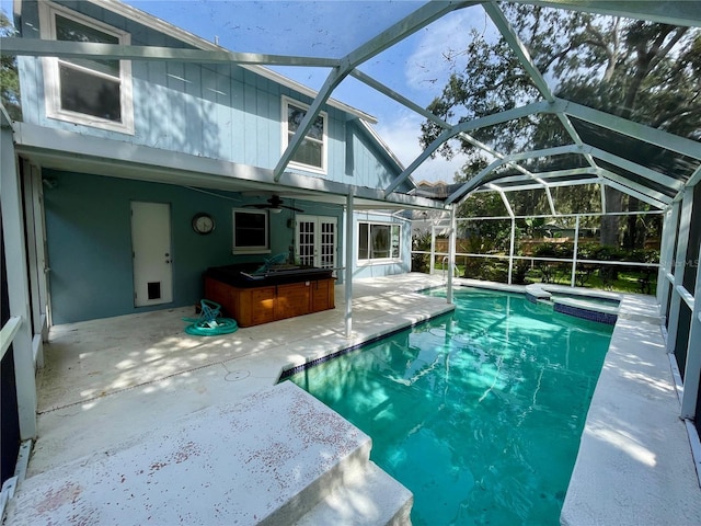 view of swimming pool with an outdoor bar, a lanai, an outdoor hot tub, and a patio area