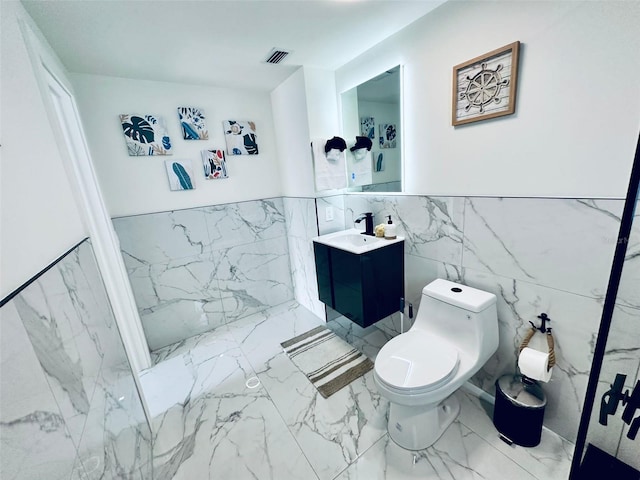 bathroom with vanity, tile walls, toilet, and tile patterned floors