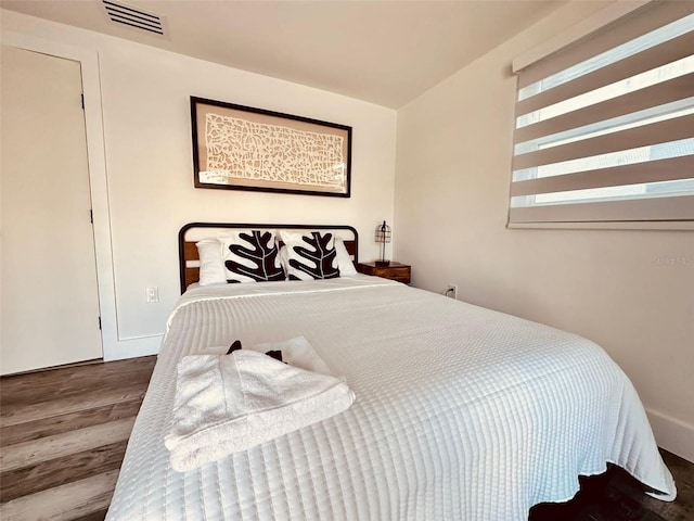 bedroom with hardwood / wood-style floors