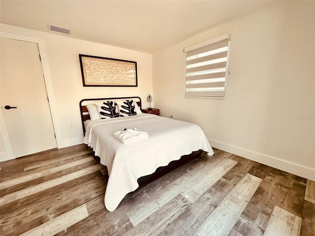 bedroom with wood-type flooring