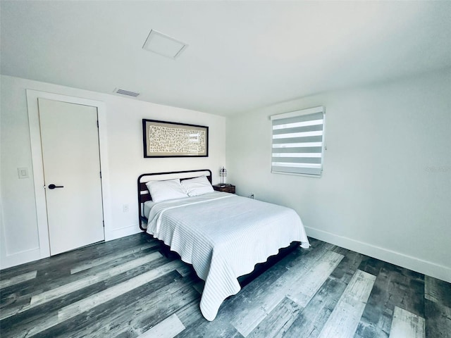 bedroom with dark hardwood / wood-style floors