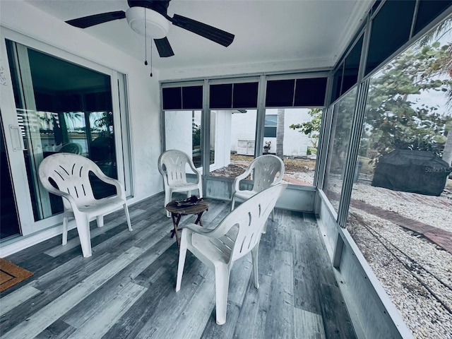 sunroom / solarium featuring ceiling fan