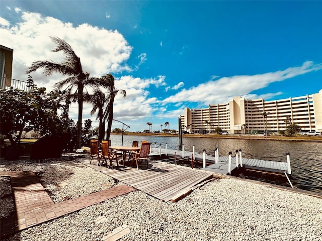 exterior space with a dock and a water view