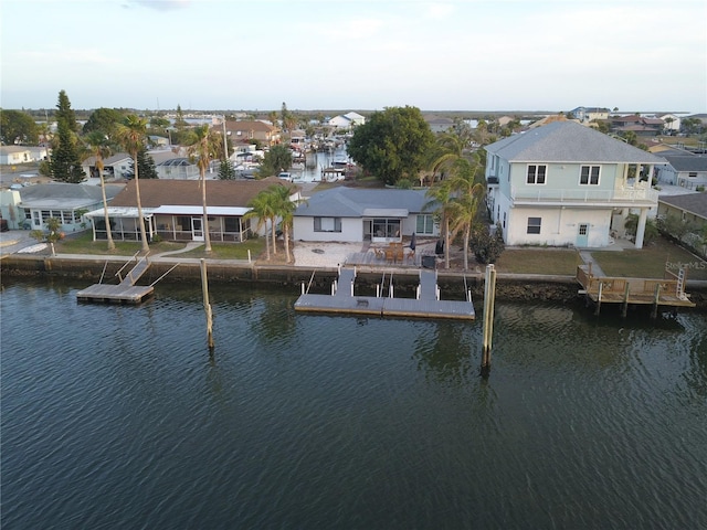 rear view of property featuring a water view and a patio area