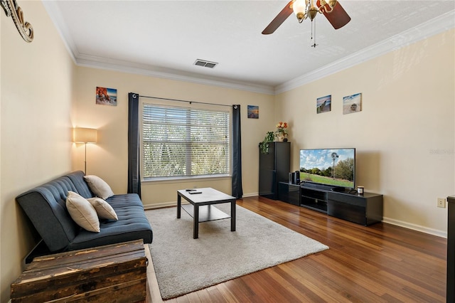 living room with hardwood / wood-style floors, ceiling fan, and ornamental molding