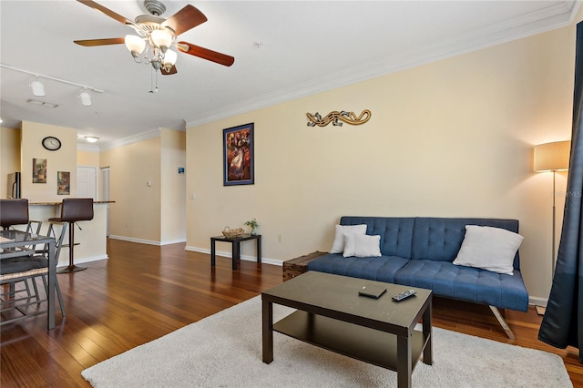 living room with dark hardwood / wood-style floors, ceiling fan, and crown molding