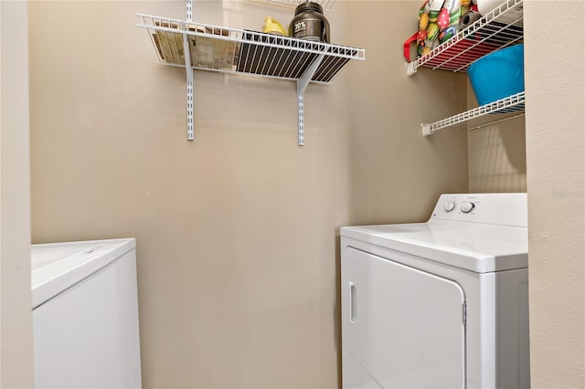 clothes washing area featuring washer and clothes dryer