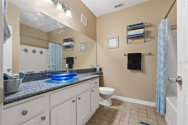 full bathroom featuring tile patterned flooring, vanity, toilet, and shower / bath combo with shower curtain