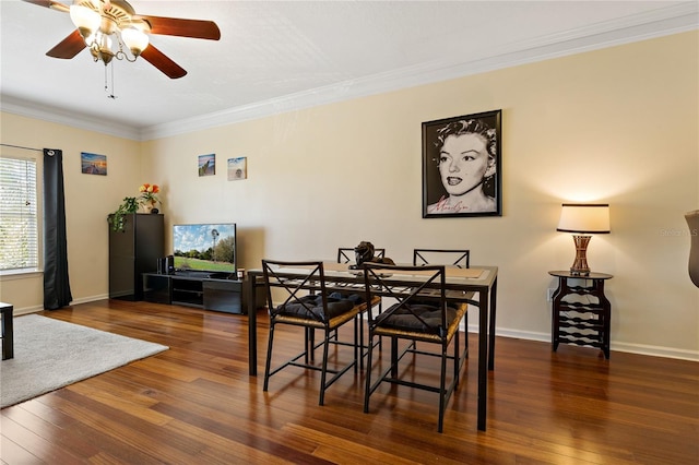 dining room featuring ceiling fan, dark hardwood / wood-style flooring, and crown molding