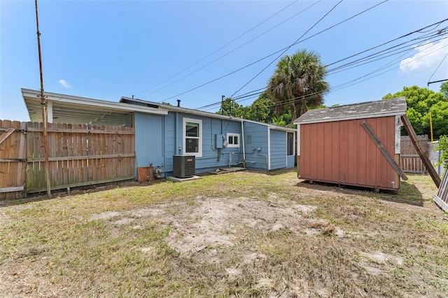 view of yard with a shed and central AC